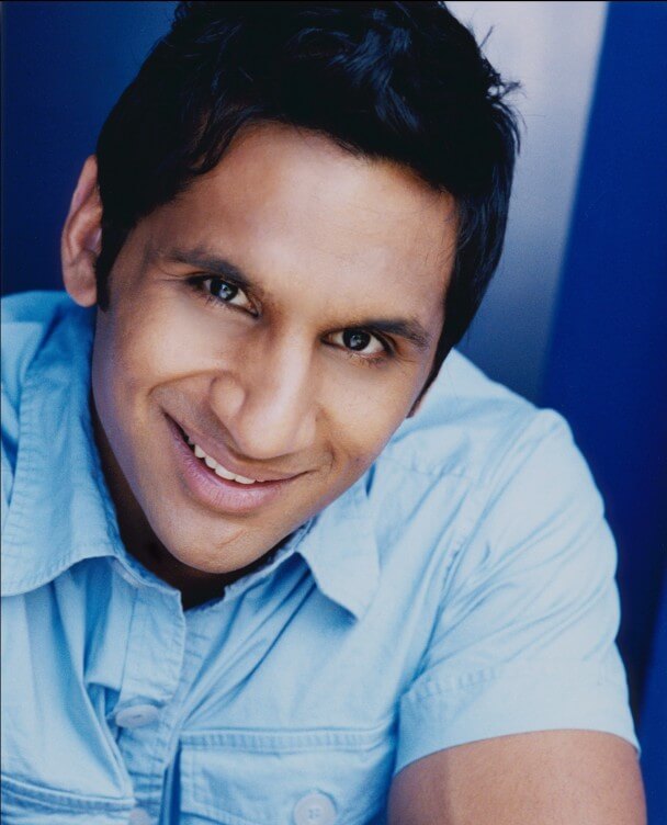 Ravi Patel is wearing a blue shirt looking directly at the camera, smiling. Color portrait.
