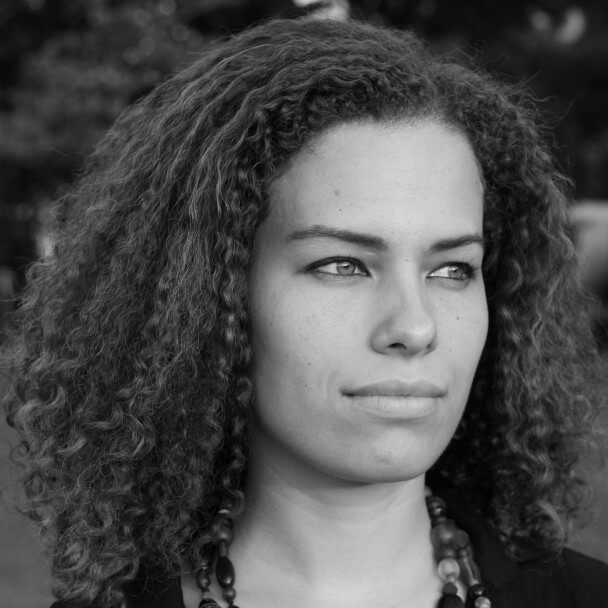 Jennifer Brea is looking off-camera. Black and white portrait.