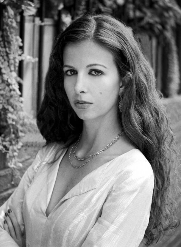 Chiara Clemente looks at the camera. Black and white portrait.