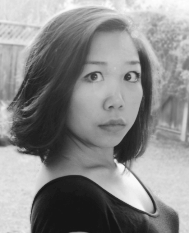 Leslie Tai looking straight ahead. She has shoulder-length dark hair. Black and white portrait.
