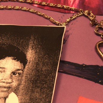 Still from Valentine Road. A picture of a young child lying on a surface next to a heart-shaped necklace.