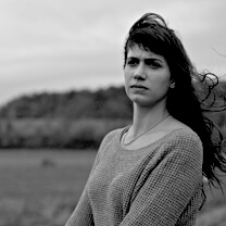 Jessica Dimmock looking off into the distance. Black and White portrait.