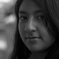 Farihah Zaman is looking at the camera. Black and white portrait.