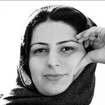 Rokhsareh Ghaem Maghami looks at the camera with her left hand touching her forehead. Black and white portrait.