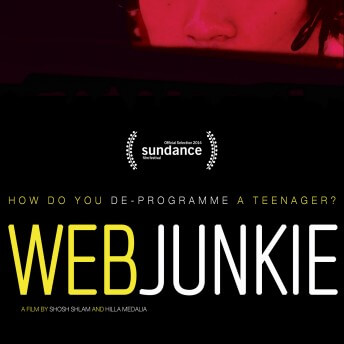 Poster of Web Junkie. A red-tinted poster of a boy's face wearing a microphone headset. The graphics on it say the film title, both director's names, Sundance selection, and the phrase "how do you deprogram a teenager?"