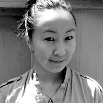 Tiffany Hsiung looks directly at the camera. Portrait in black and white.