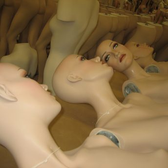 Women mannequins with no hair in sequence.