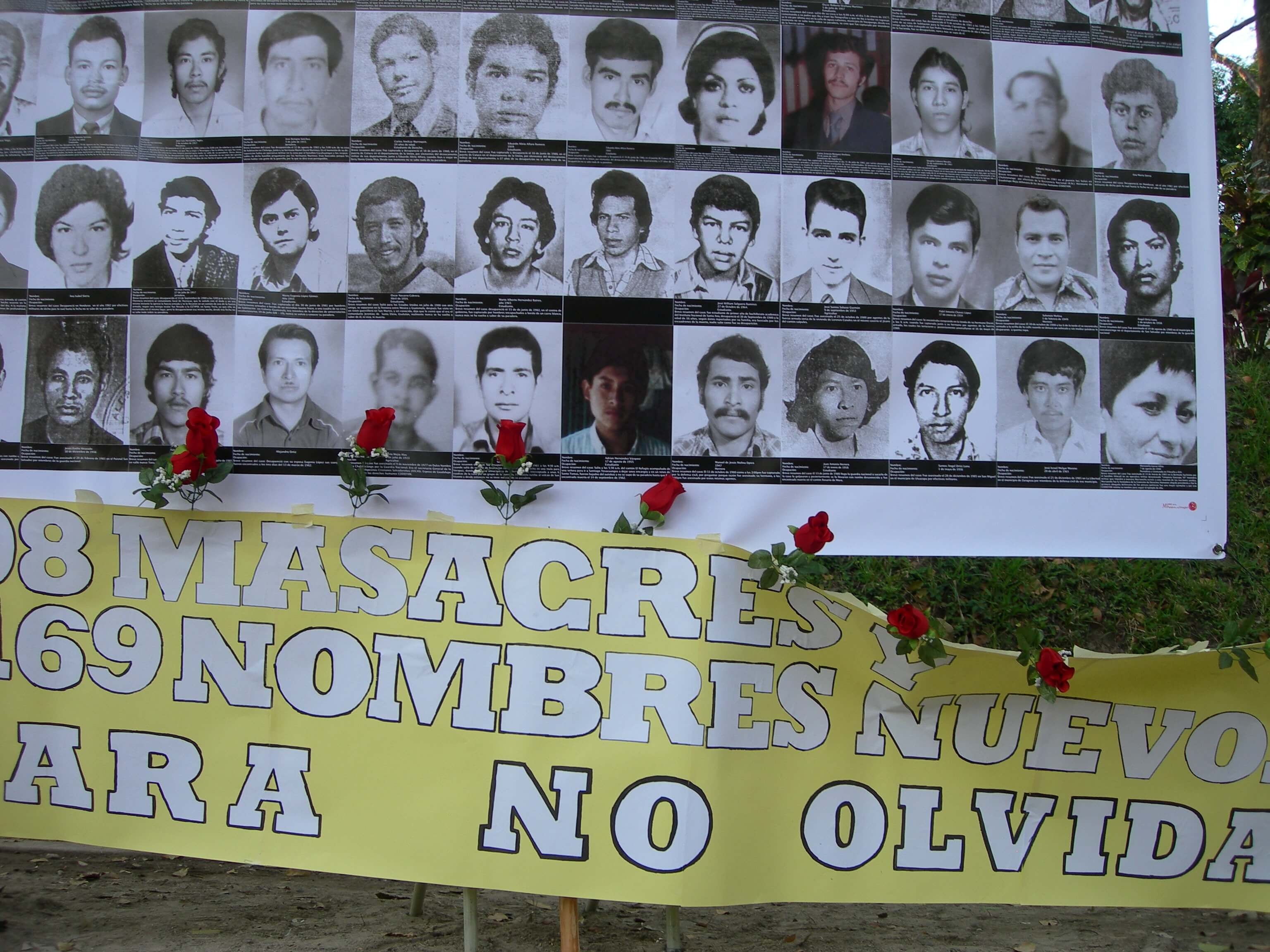 A printed banner with photographs of the missing children during the civil war in El Salvador.