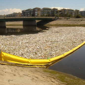 Still from Bag It. Ballona creek contaminated with plastics.