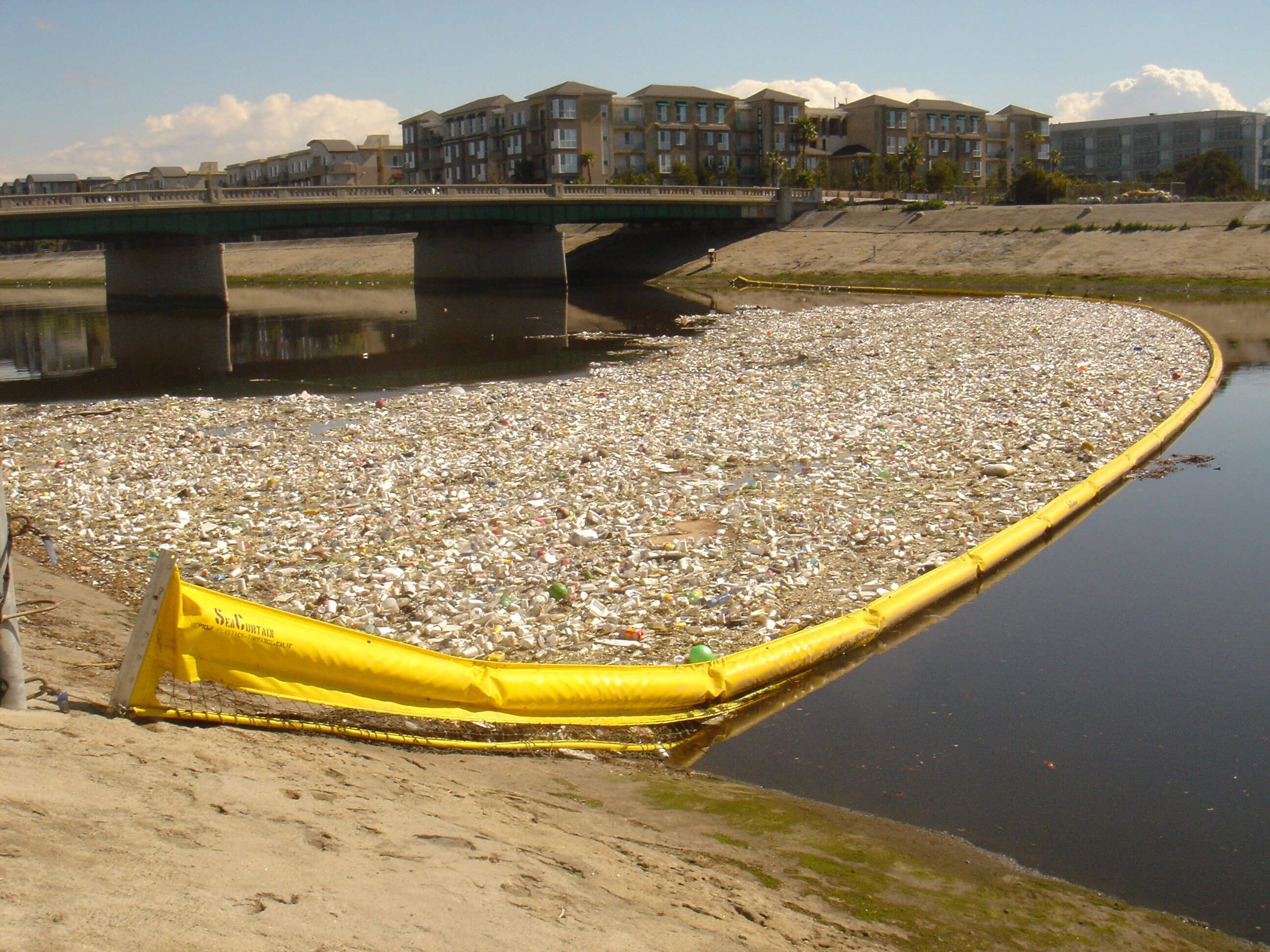 Still from Bag It. Ballona creek contaminated with plastics.