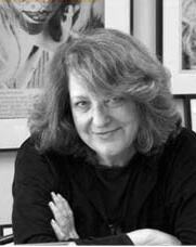 Lynn Hershman Leeson looks at the camera and slightly smiles. She wears a black top. Black and white portrait.
