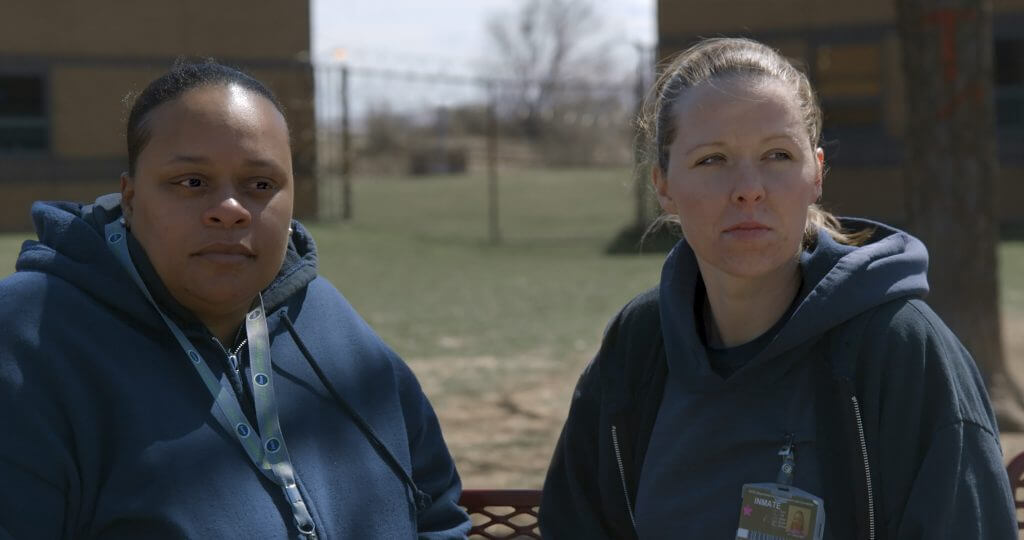 Still from Apart. Tomika and Amanda in the prison yard