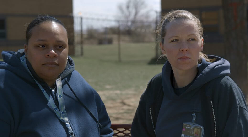 Still from Apart. Tomika and Amanda in the prison yard