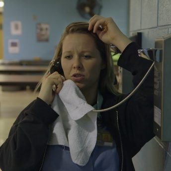 Still from Apart. Amanda is calling her son from prison.