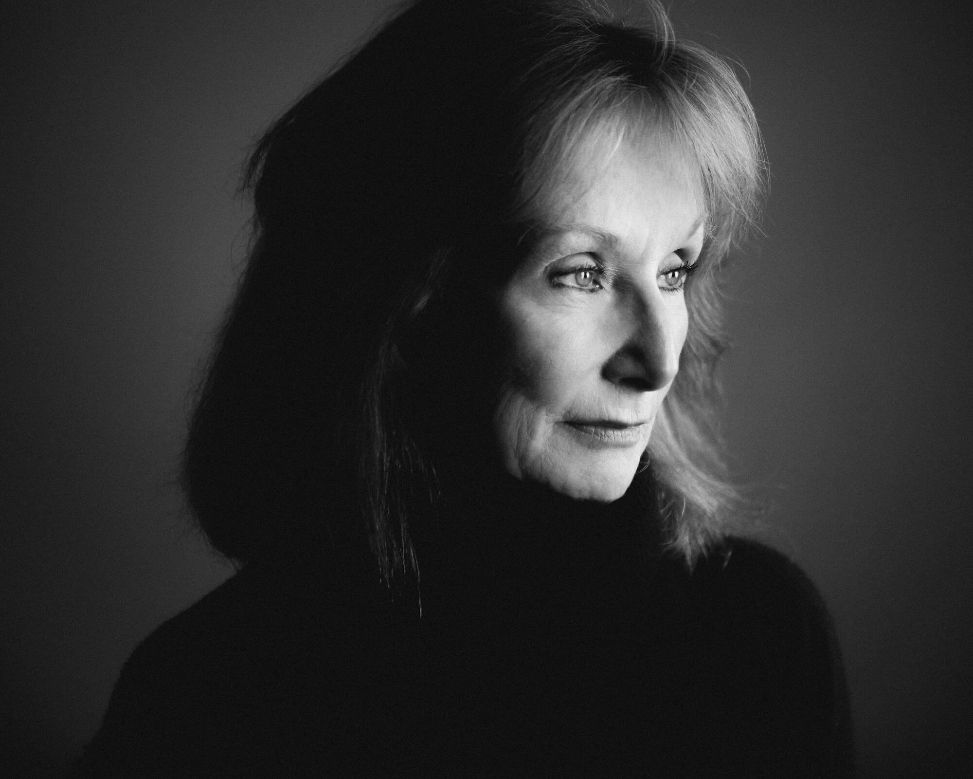 Maria Finitzo is looking off-camera. Black and white portrait.