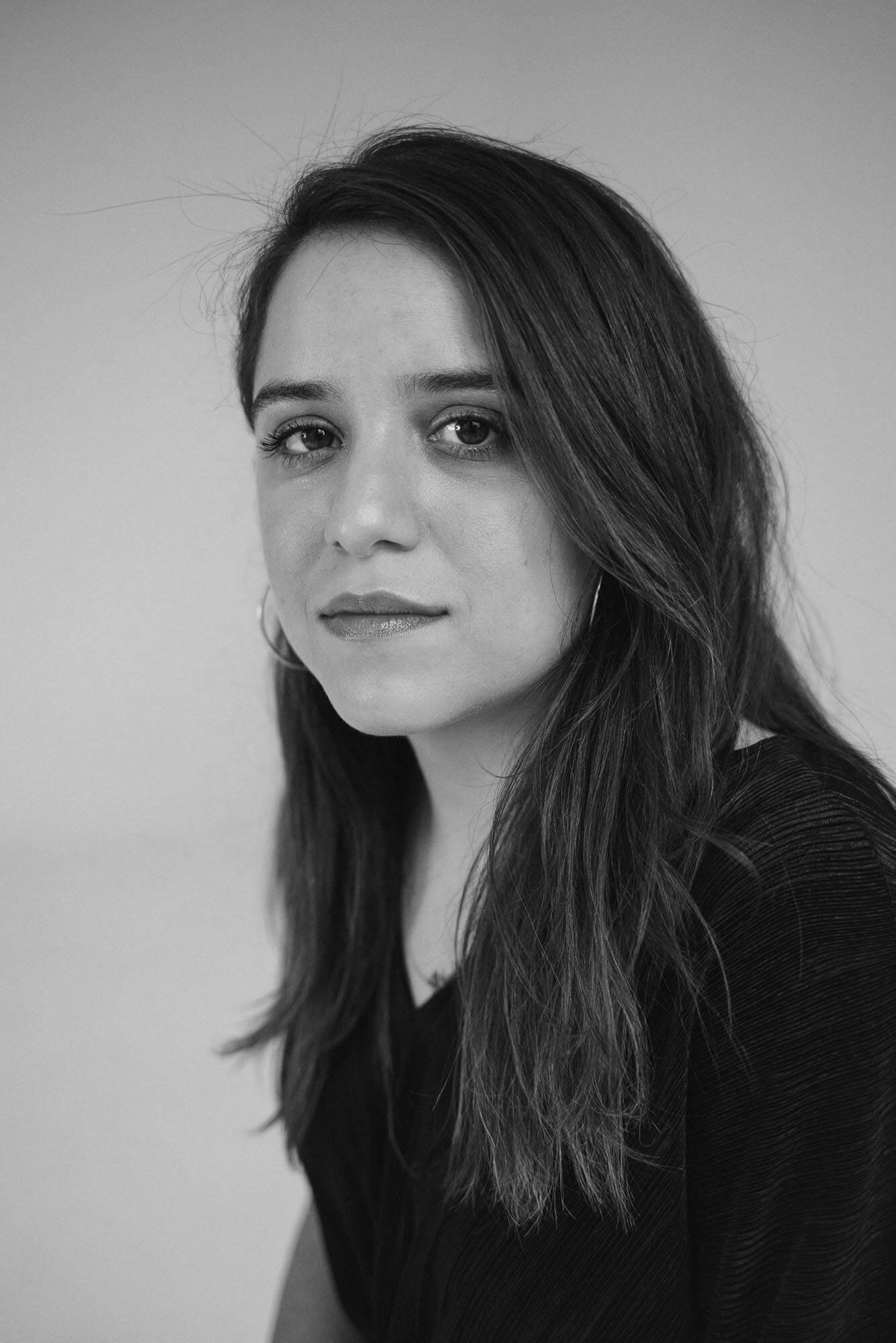 Isabel Castro looks at the camera. Black and white portrait.