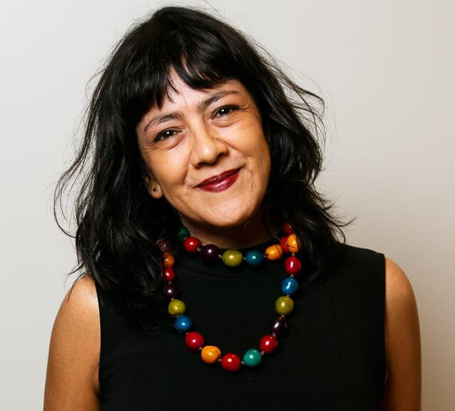 Headshot image of Lucila Moctezuma. Lucila is a Mexican woman with long black hair and a colorful necklace.