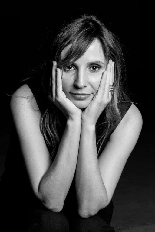 Director Petra Costa’s headshot in black and white