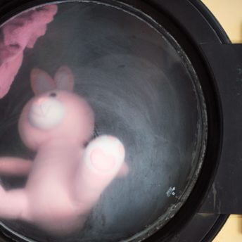 Close-up of a stuffed animal inside of a washing machine