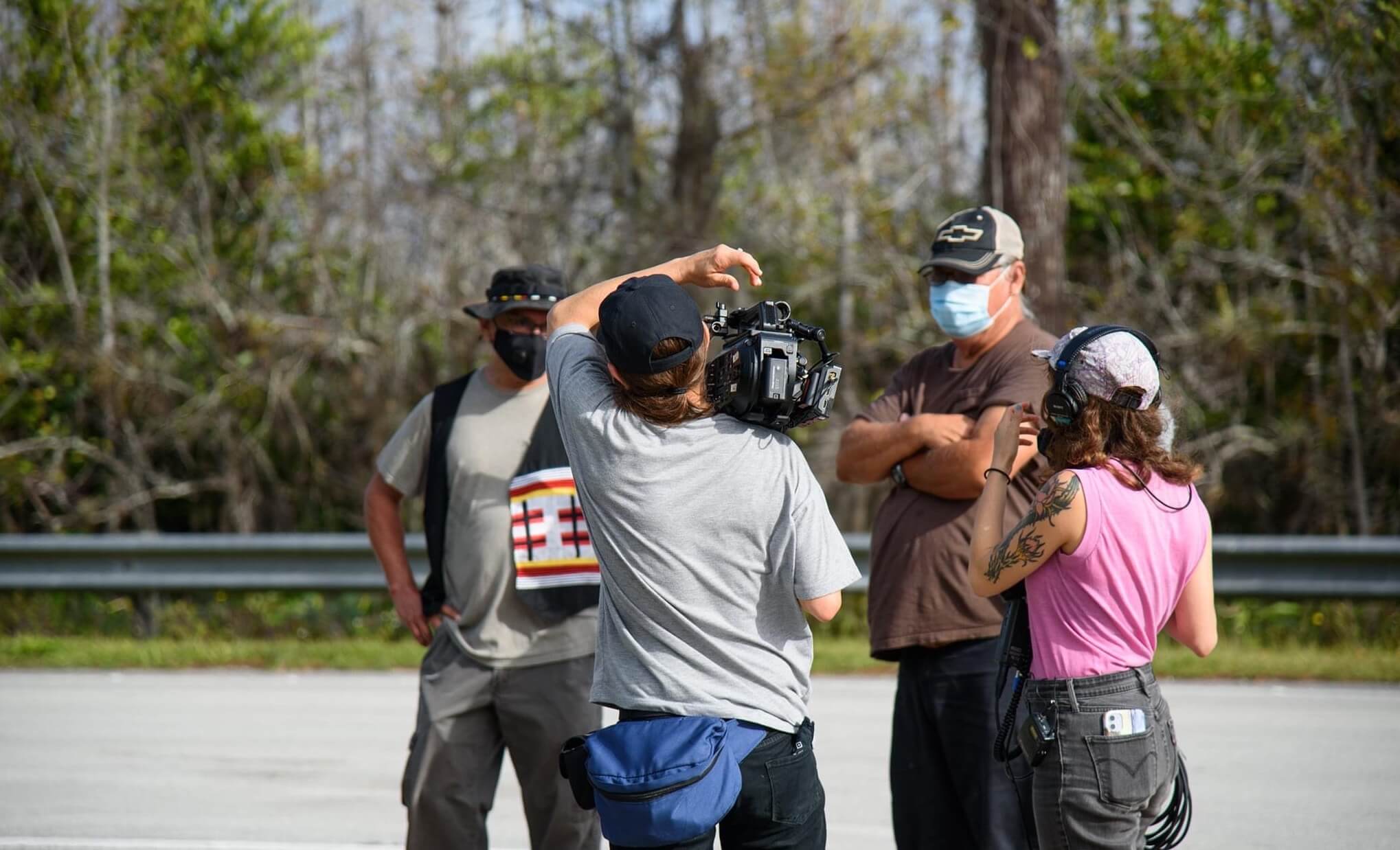 Jesse and Sasha documenting two participants in a walk through the Big Cypress.