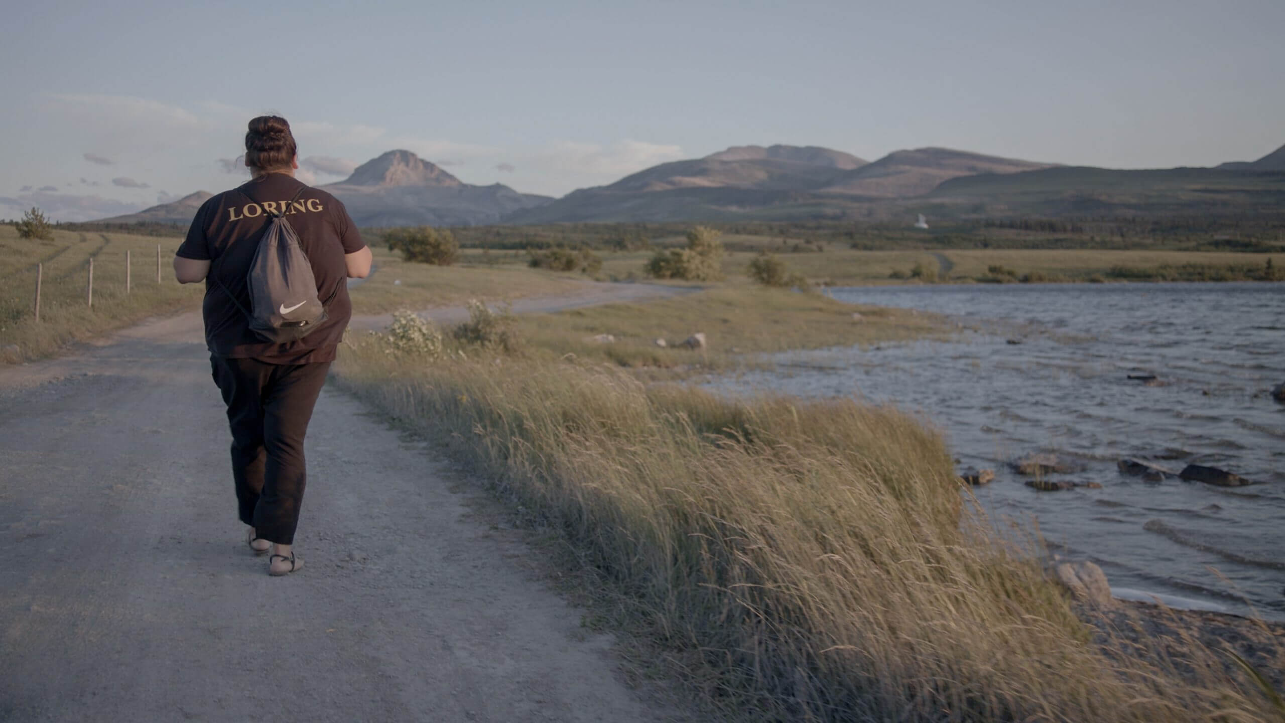 This still is of Kimberly Loring Heavyrunner walking at Twins Lake near her home Heart Butte, on the Blackfeet Reservation. She spent much time there with her sister Ashley when they were young.