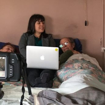 Director Gabriela Pena and her grandparents being filmed while lying in bed.