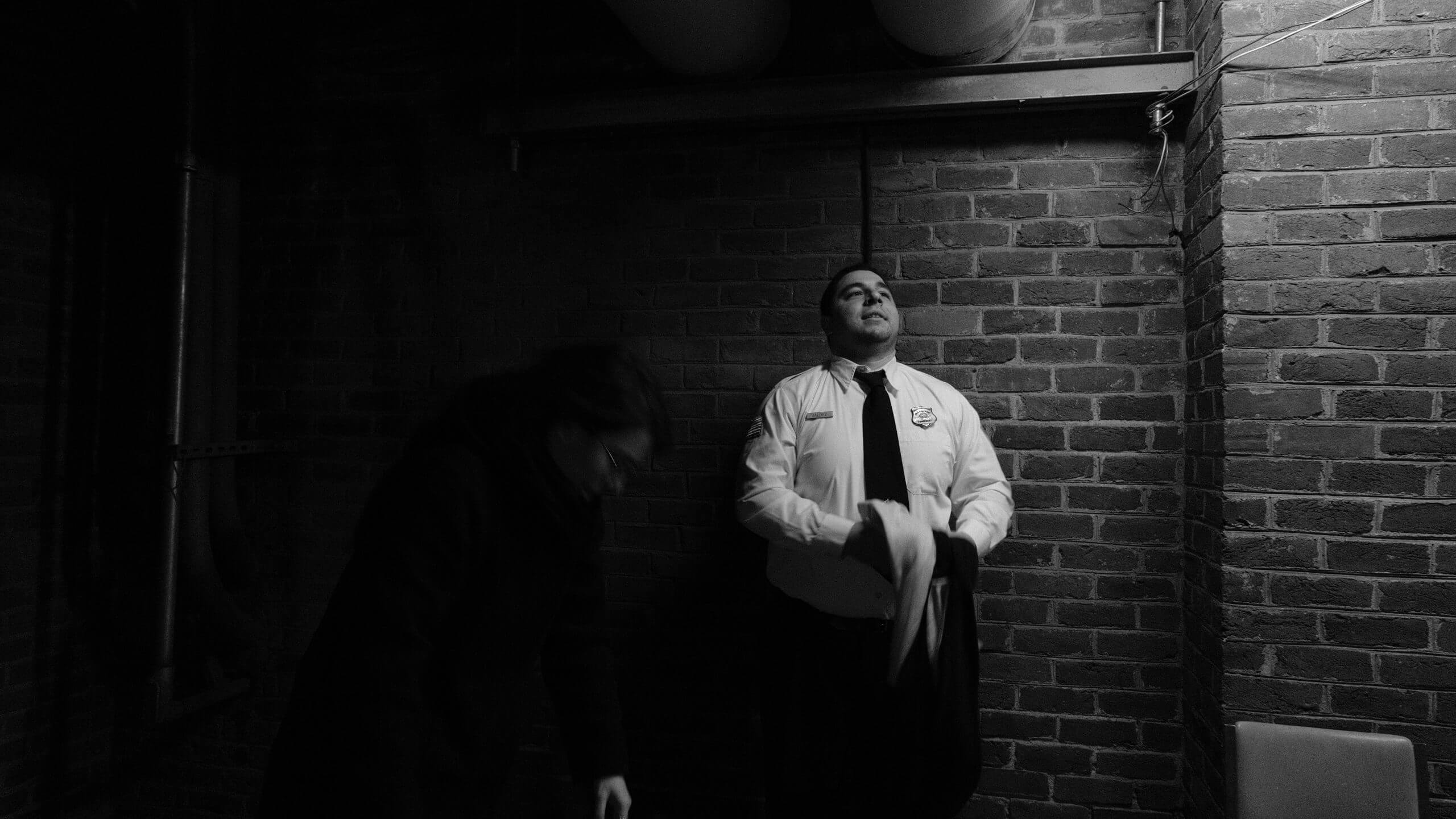 Medium shot of an actor dressed as a police officer looking up to the sky