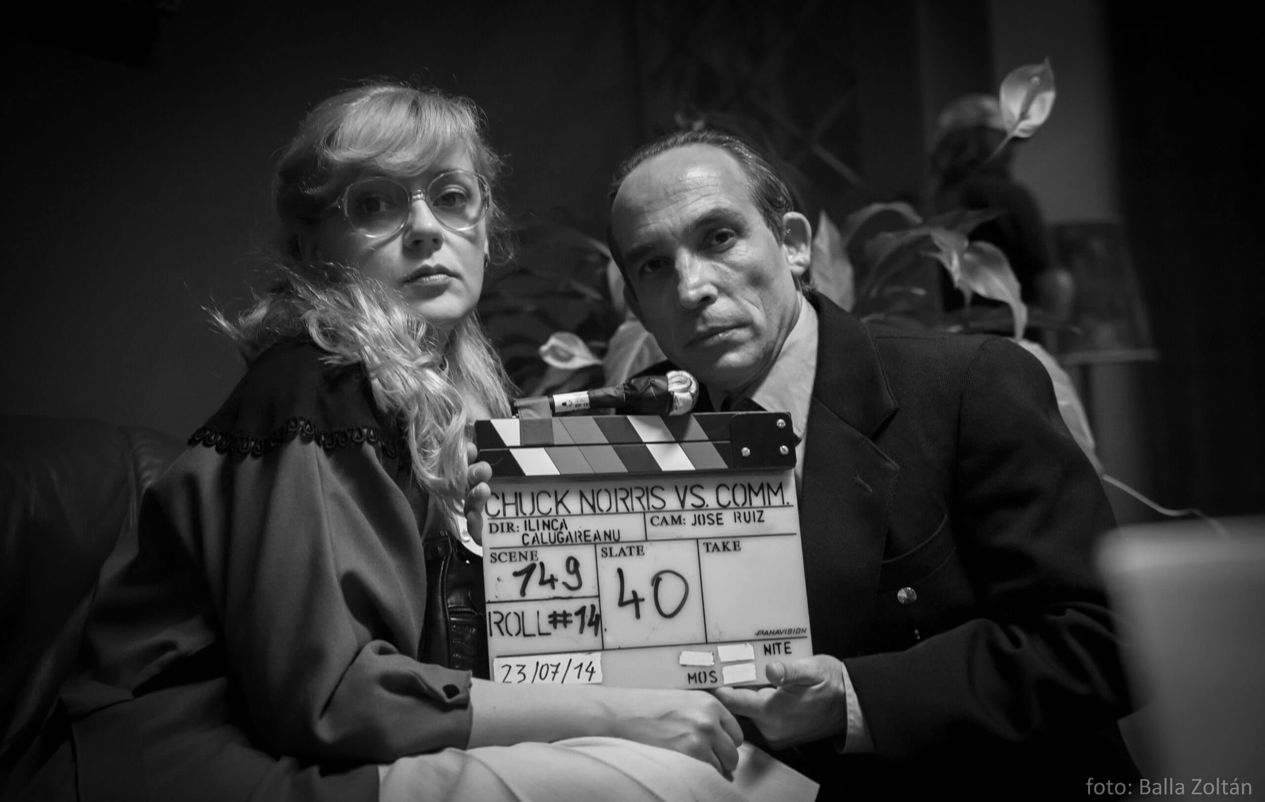 Still from Chuck Norris vs Communism. Ana Maria Moldovan and Dan Chiorean, the actors playing the film’s main characters, pose with the clapboard (photographer Balla Zoltán)