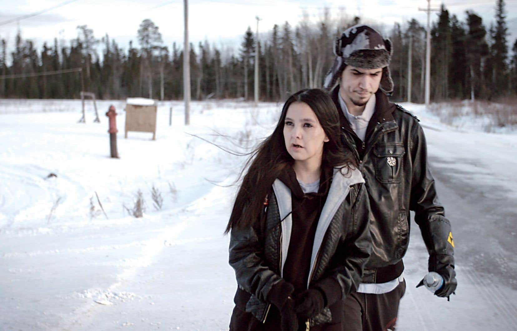 Still from Indictment: The Crimes of Shelly Chartier. Shelly Chartier and her husband Rob Marku walk down a snowy rural road with tense looks on their faces. Shelly is looking away from the camera to her left and Rob is looking downwards.