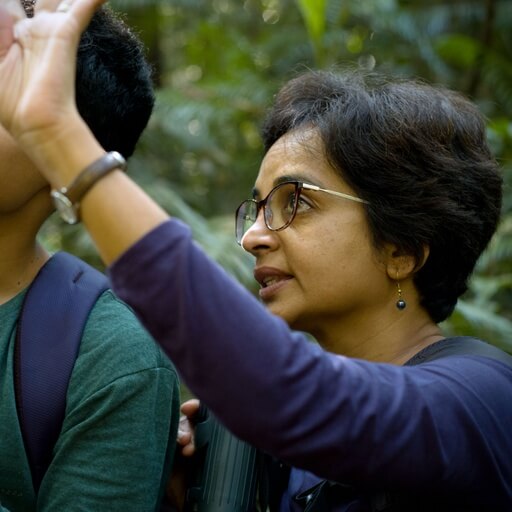 Documentary filmmaker Farida Pacha on location in an Indian rain forest.