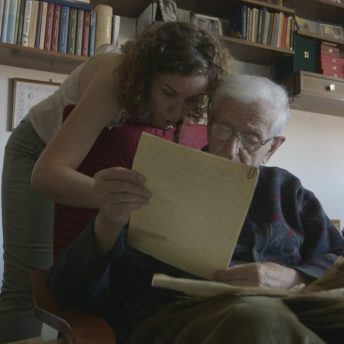 Mila Turajlić and Stevan Labudović looking through his personal archives at his home in Belgrade.