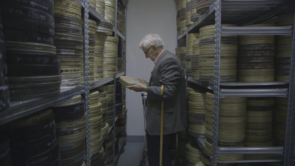 Stevan Labudović in the archives of the Yugoslav Newsreels surrounded by reels of films he shot during the Algerian Liberation War.