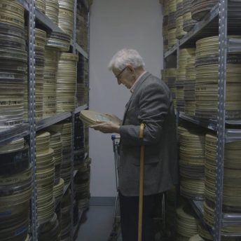 Stevan Labudović in the archives of the Yugoslav Newsreels surrounded by reels of films he shot during the Algerian Liberation War.