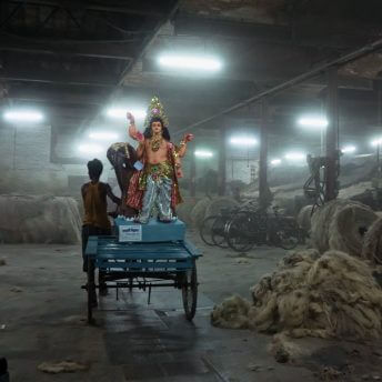 A statue of Lord Vishwkarma being carted into a jute factory