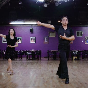 Middle Aged Asian couple dancing in ballroom studio
