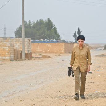 The director of the film, Maryam Ebrahimi with a camera on the front lines in Rojava.