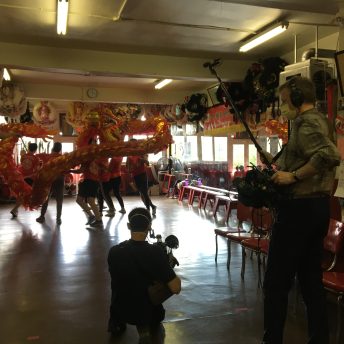 Crew filming a drangon dance practice in the Hon Hsing Athletic Club in Vancouver's Chinatown