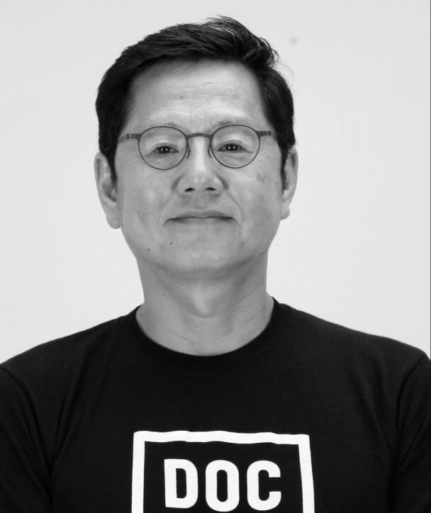 Gary Byung Seok Kam Co Producer of From the Shadows. Black and white headshot.
