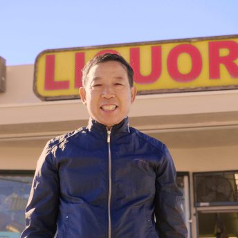Hae Sup Um standing in front of his liquor store