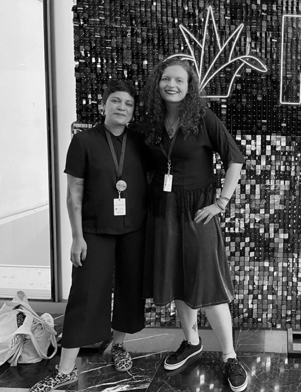 Michelle Plascencia and Merle Iliná smiles to the camera at Guadalajara International Film Festival. Black & white image.