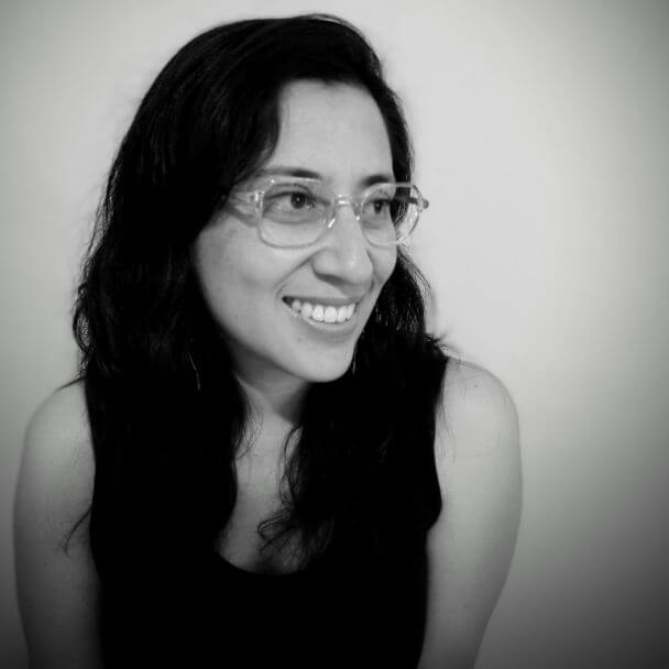 In a black and white picture, Patricia Balderas is smiling after being noticed that her first film was selected in Morelia International Film Festival.