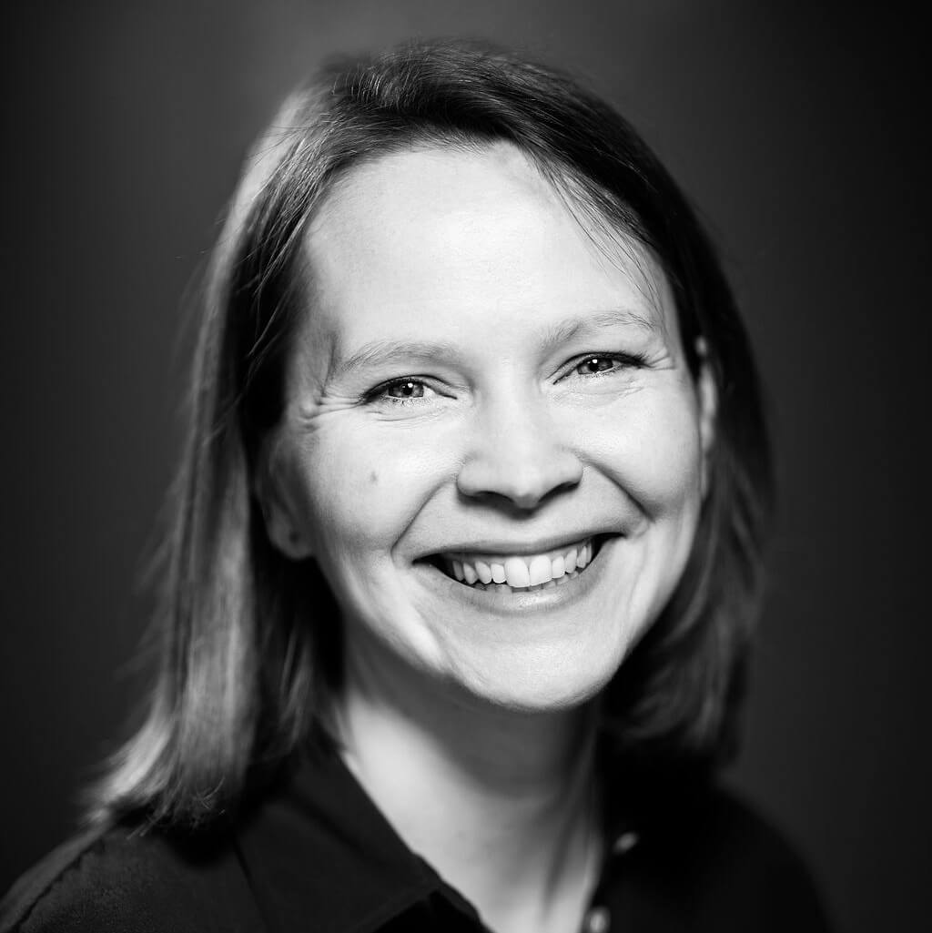 Sarah Anderson looking directly at camera and smiling. Black and white photo.