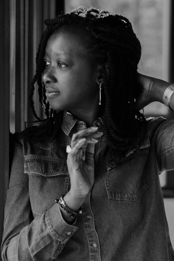 Black and white portrait of Katy Léna Ndiaye. Katy looks away from camera.