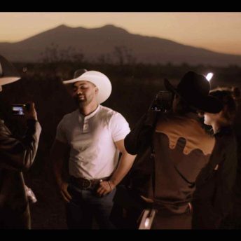 Crew members shoot protagonist Noe in field at dark.